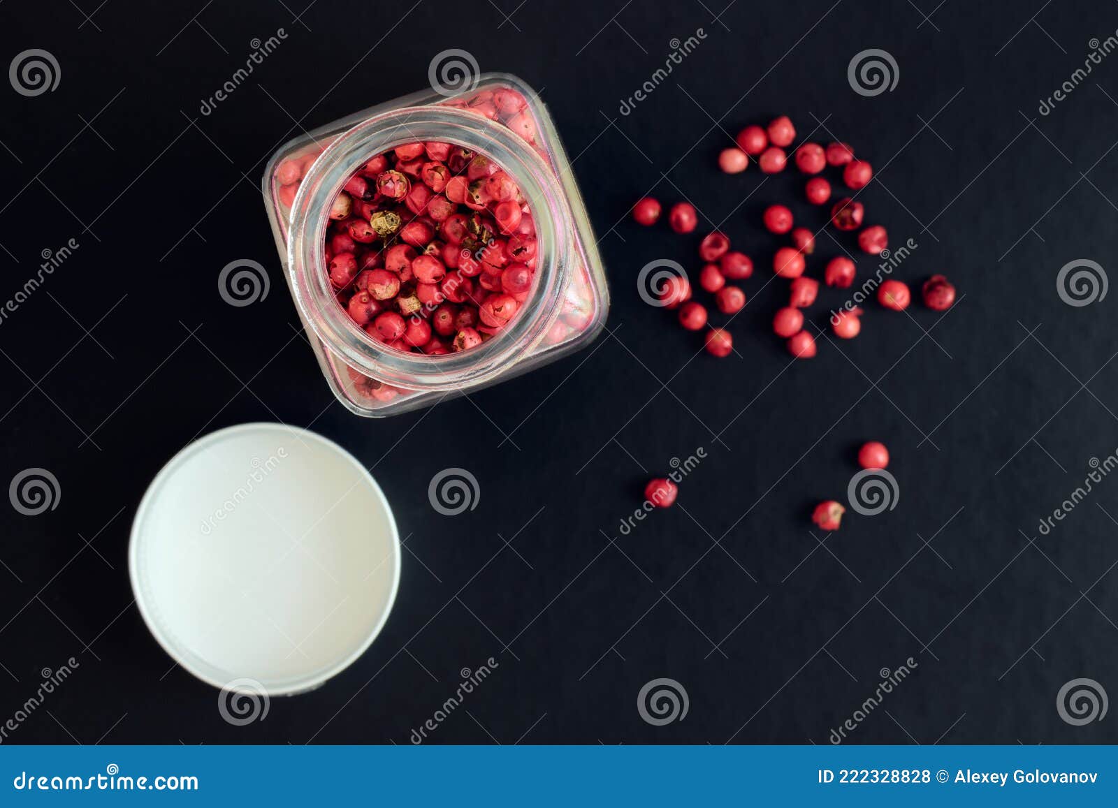 Pink Peppercorns in a Glass Jar on a Dark Background, Shallow Depth of