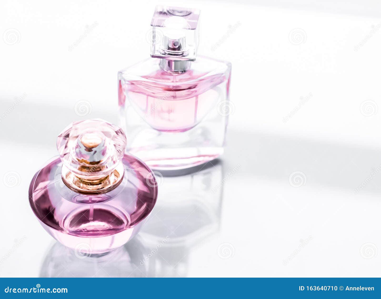 Pink perfume bottle on glossy background, sweet floral scent, glamour  fragrance and eau de parfum as holiday gift and luxury beauty cosmetics  brand design, Stock image