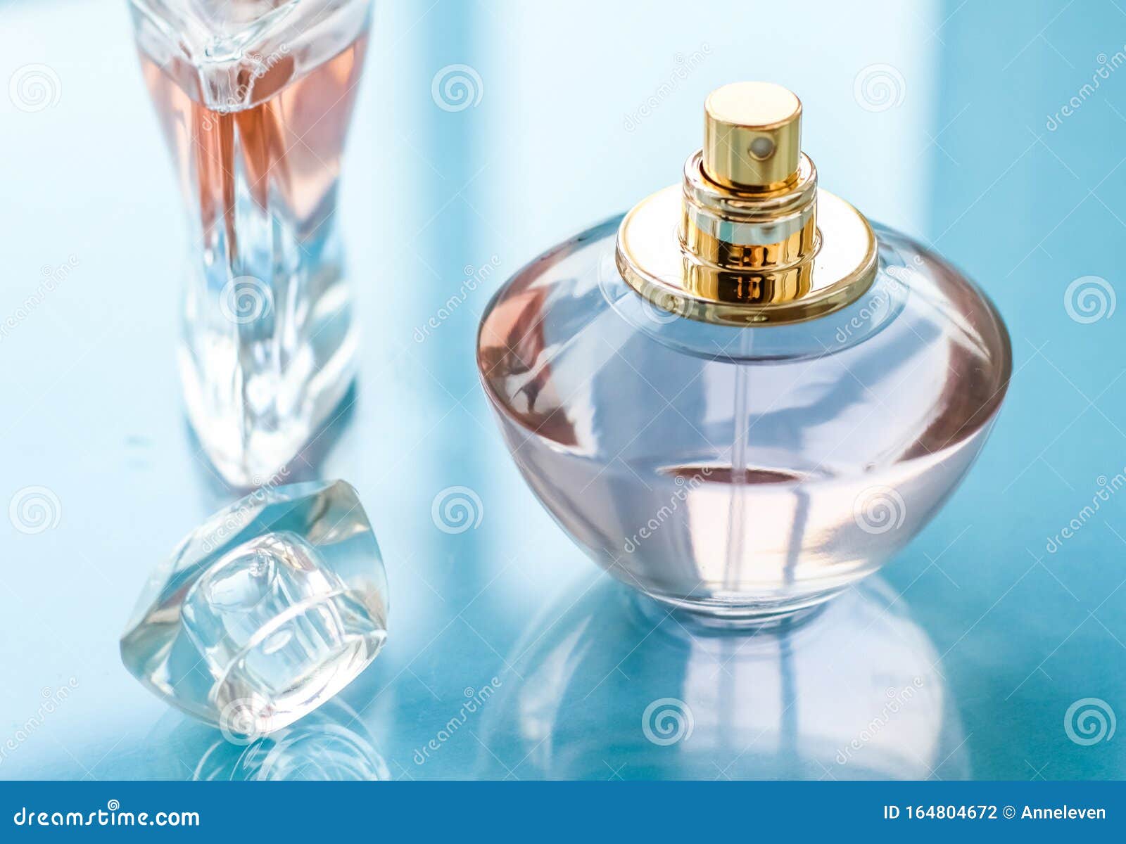 Pink perfume bottle on glossy background, sweet floral scent, glamour  fragrance and eau de parfum as holiday gift and luxury beauty cosmetics  brand design, Stock image