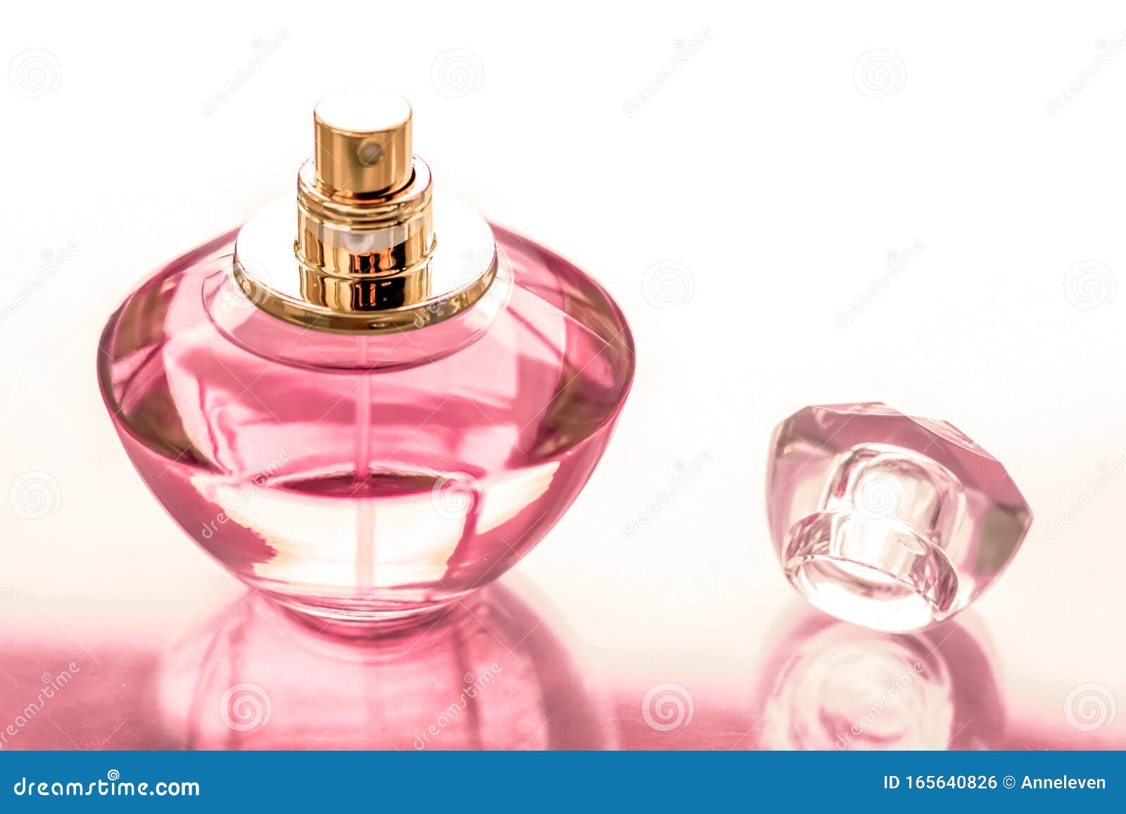 Pink perfume bottle on glossy background, sweet floral scent, glamour  fragrance and eau de parfum as holiday gift and luxury beauty cosmetics  brand design, Stock image