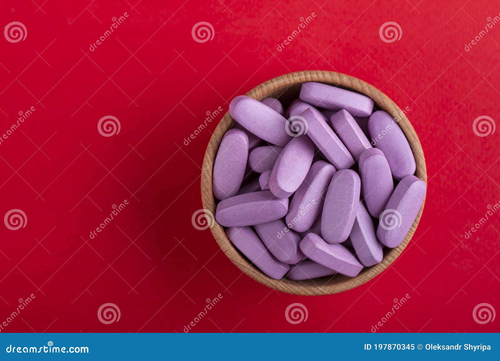 pink pills in a wooden bowl. medical medicine. space for text. medicine creative 