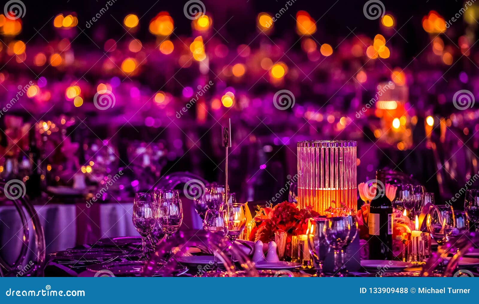 pink and purple christmas decor with candles and lamps for a large party or gala dinner
