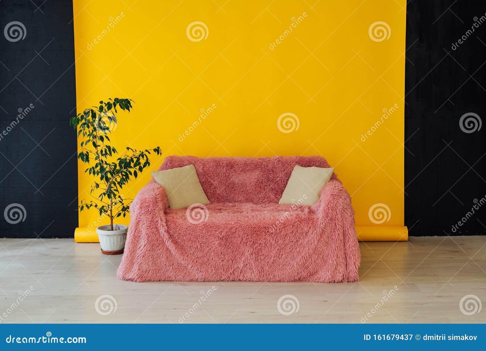 Pink Sofa in the Interior of the Room with a Yellow Background Stock