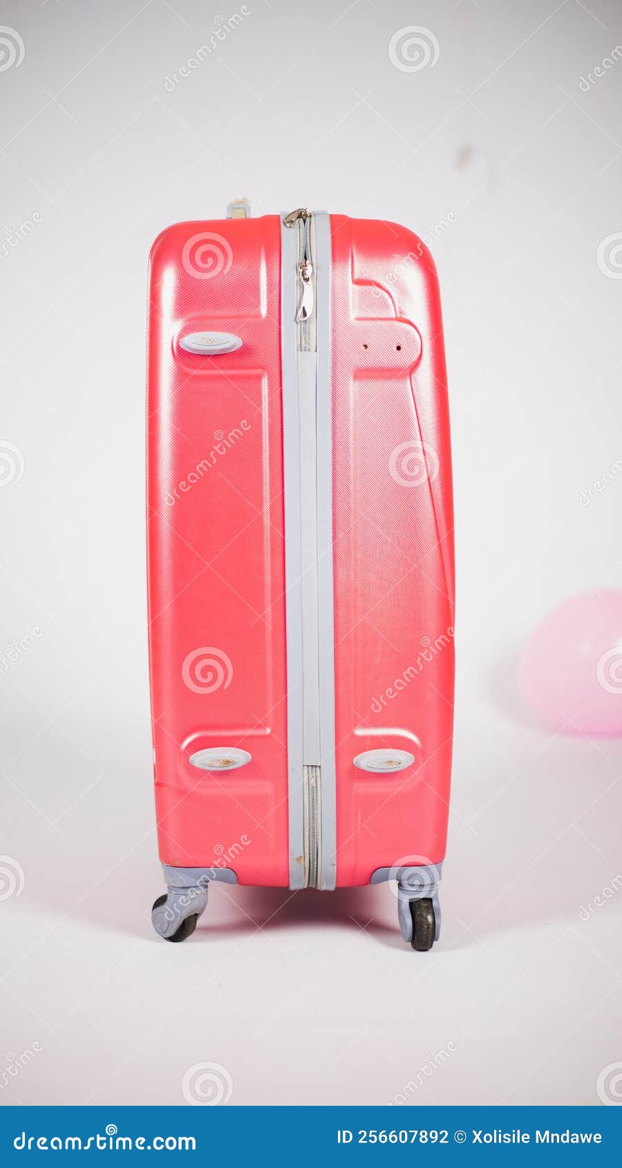 Pink suitcase stock photo. Image of hand, orange, pink 256607892