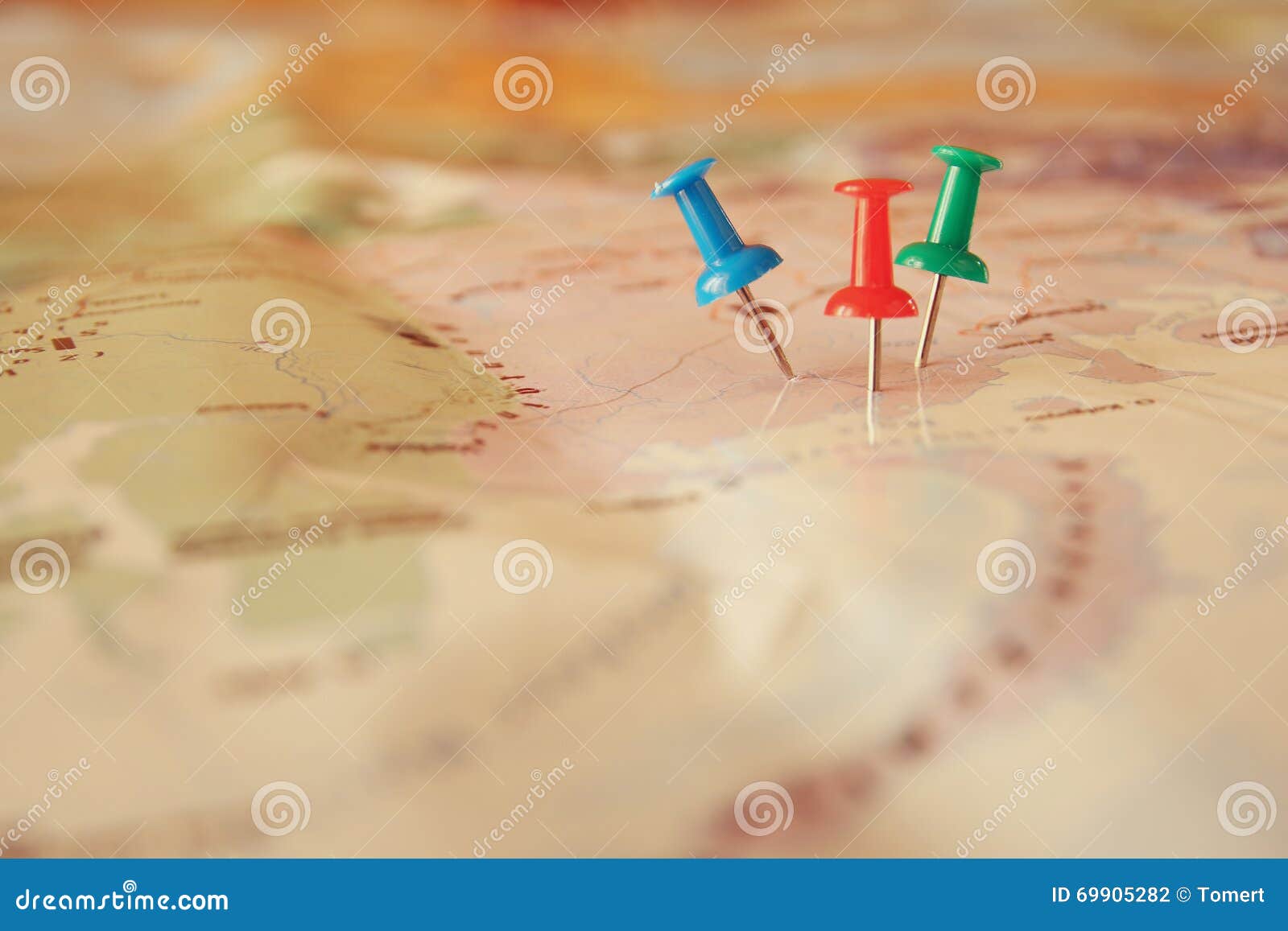 pins attached to map, showing location or travel destination