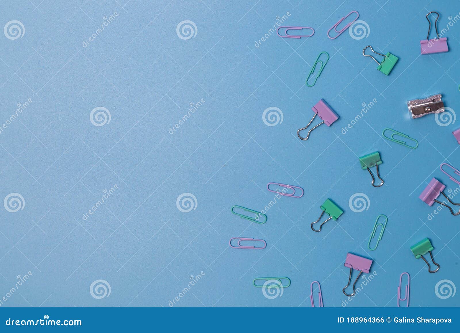 pins and paper clips collection on blue background