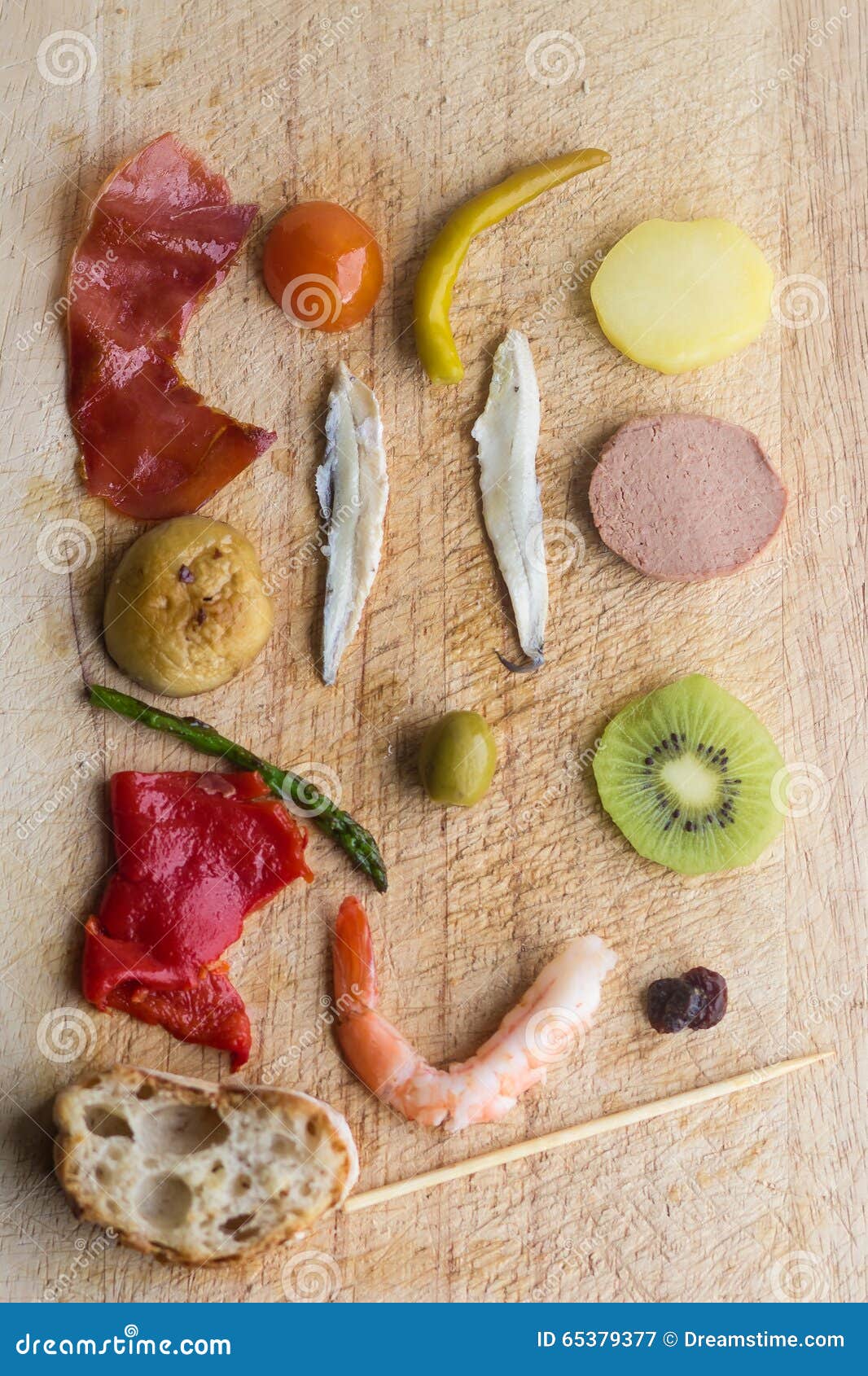 pintxos pintxo ingredients on a rustic board, food from the basque country