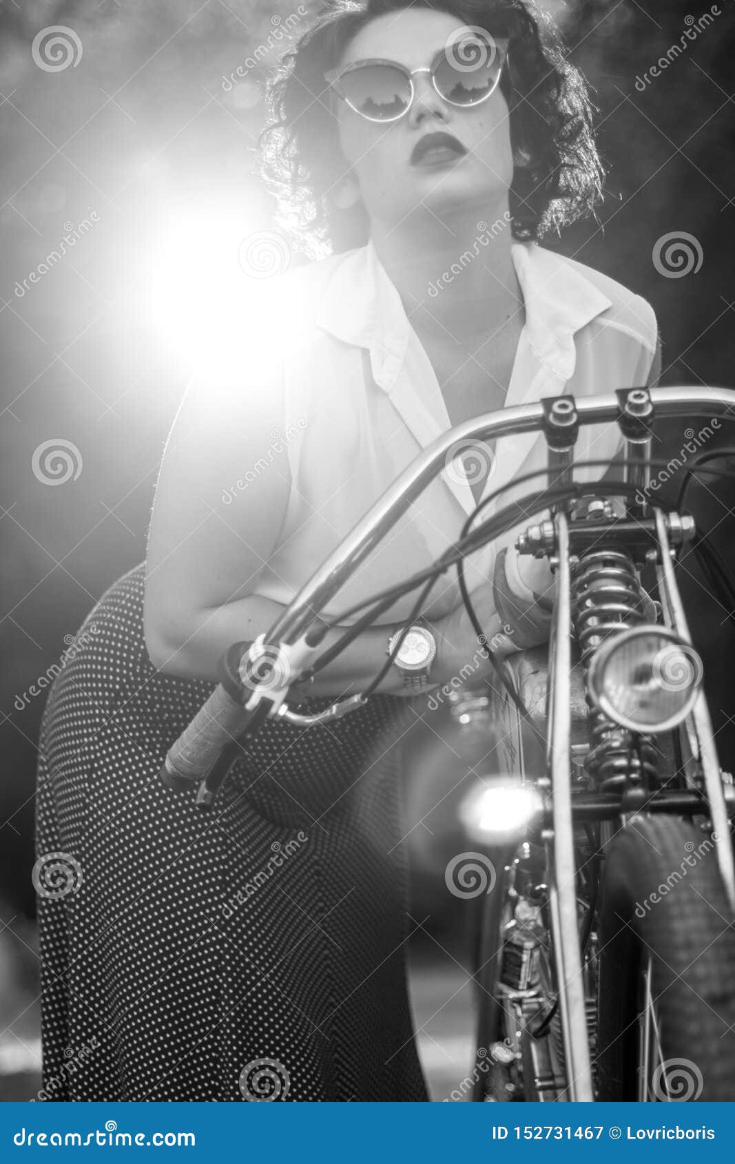 A Pinup Woman In A Vintage Dress Posed Next To The Old Motorcycle Stock