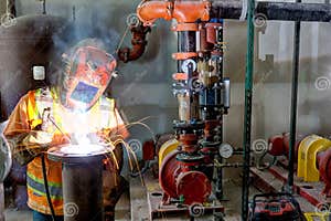 A Pipe Fitter Installing A Fire Suppression System Editorial Photo 