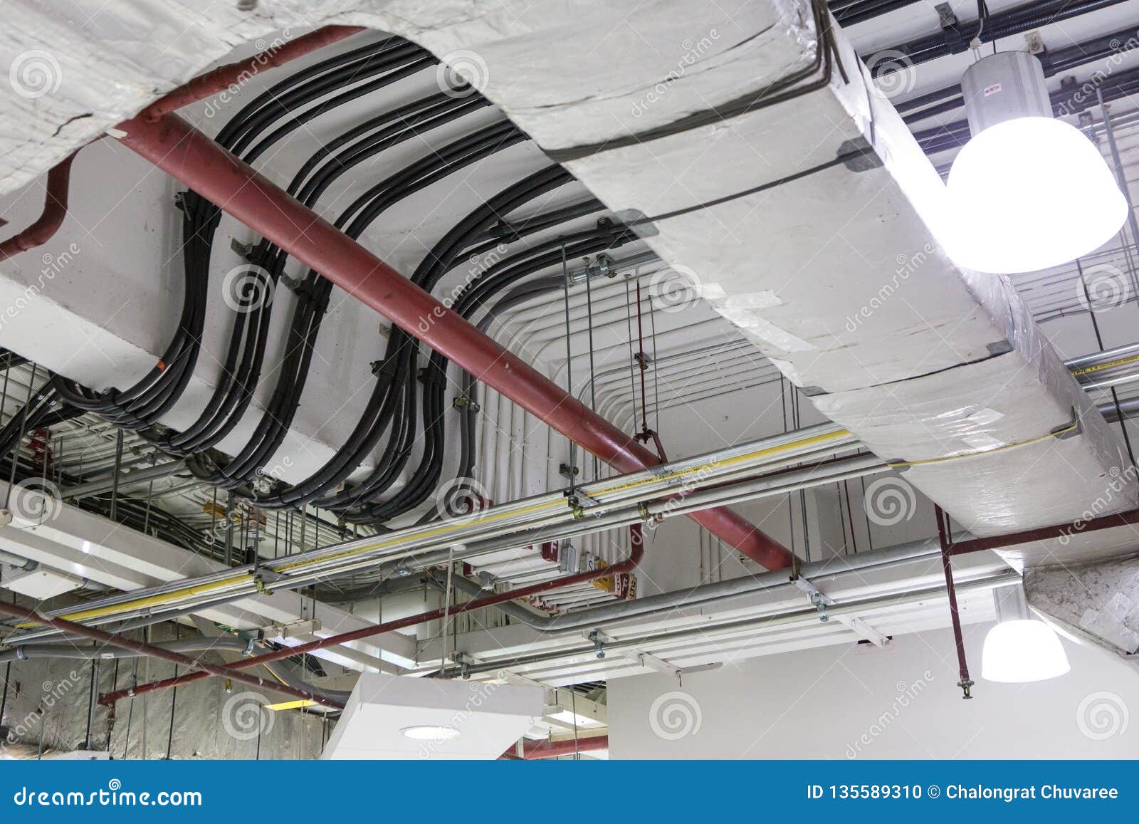 Pipes of Air Conditioning and Ceiling Electric System Stock Photo