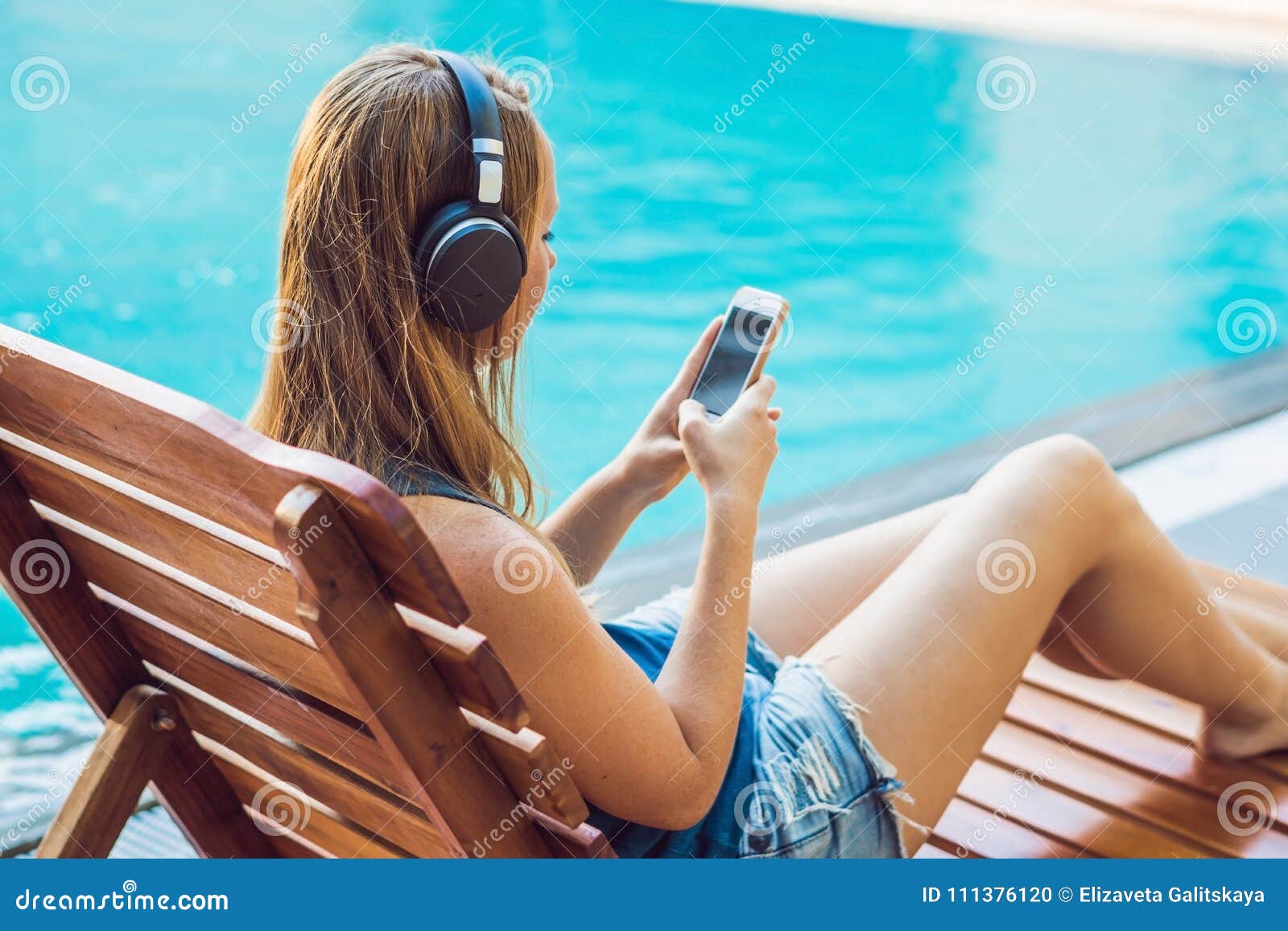 Piscina Cercana Relajante De La Mujer Feliz Del Smartphone Que Escucha Con  Auriculares De Botón Fluir Música Muchacha Hermosa Que Foto de archivo -  Imagen de costa, teléfono: 111376120