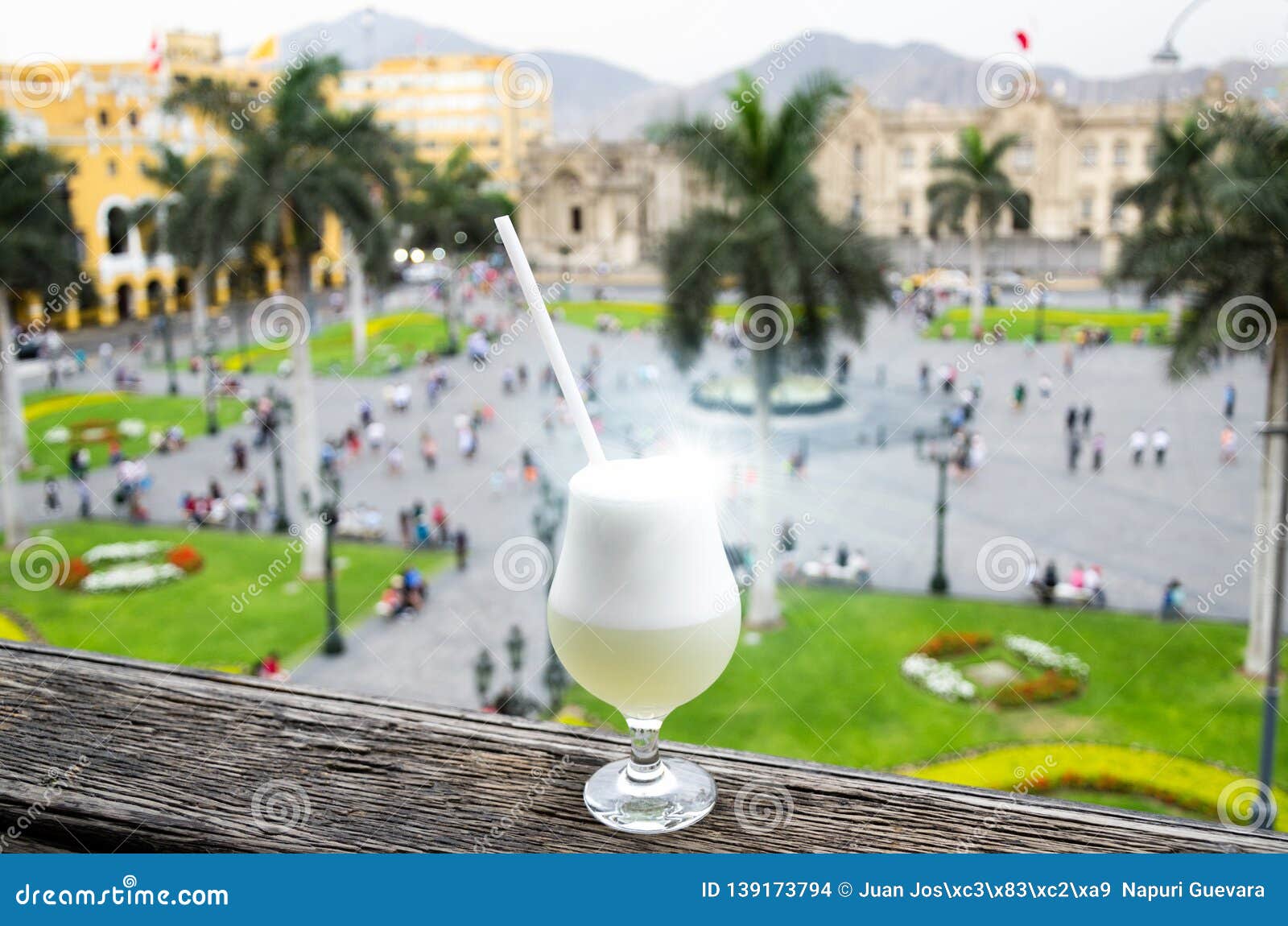 pisco sour homemade cocktail with the background of the main square of lima