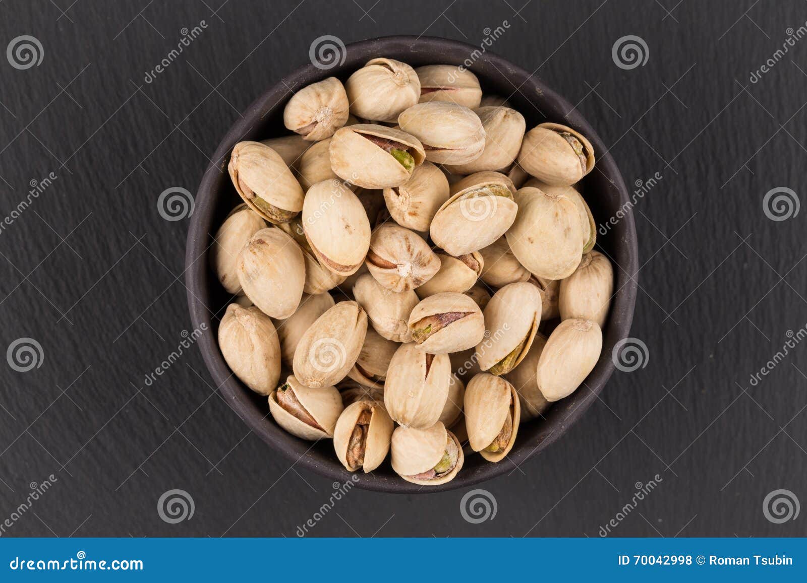 Pistachio nuts in bowl stock photo. Image of ingredient 70042998