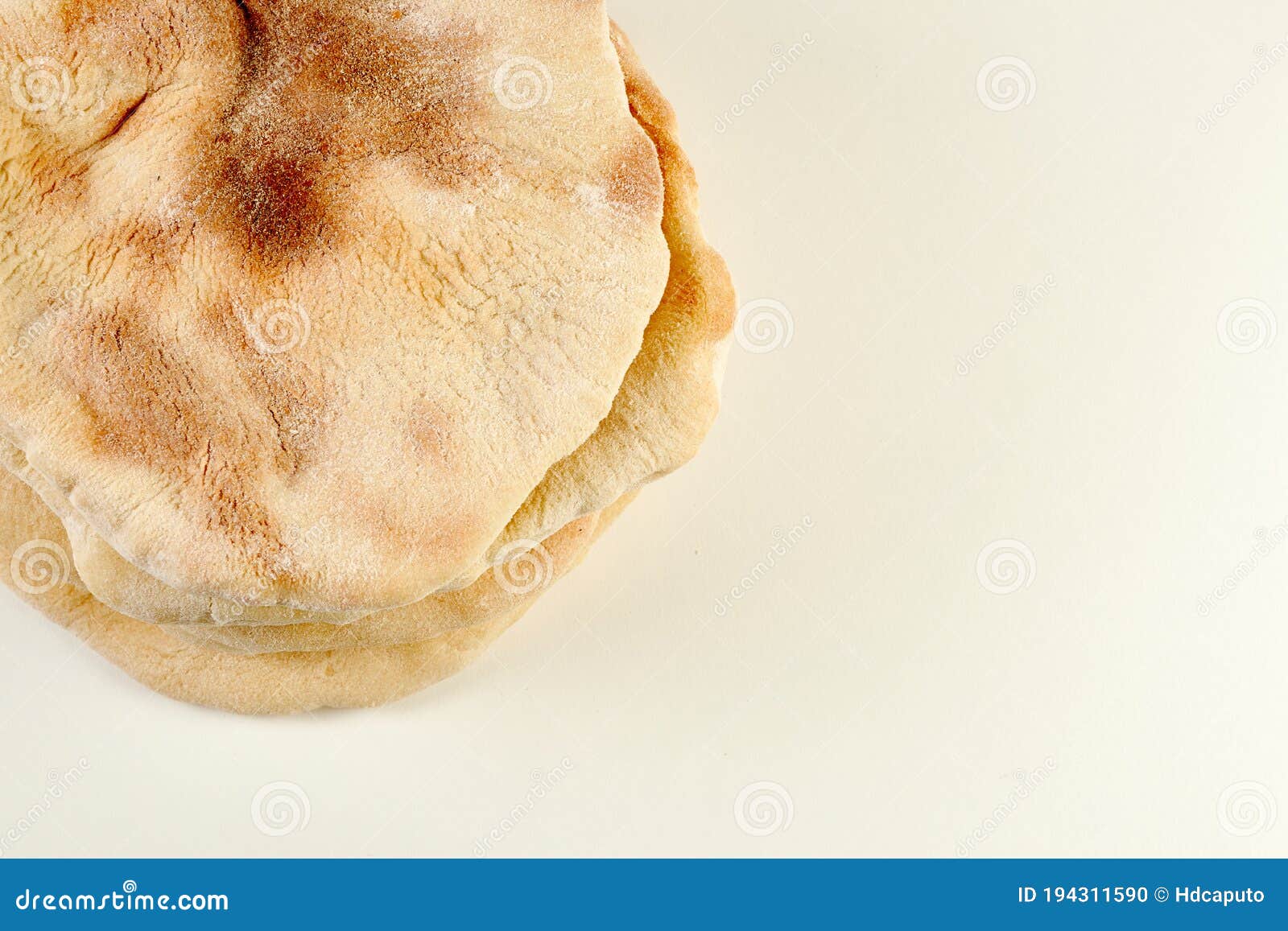 Pita or Arabic Breads on White Surface with Writing Space Stock Photo
