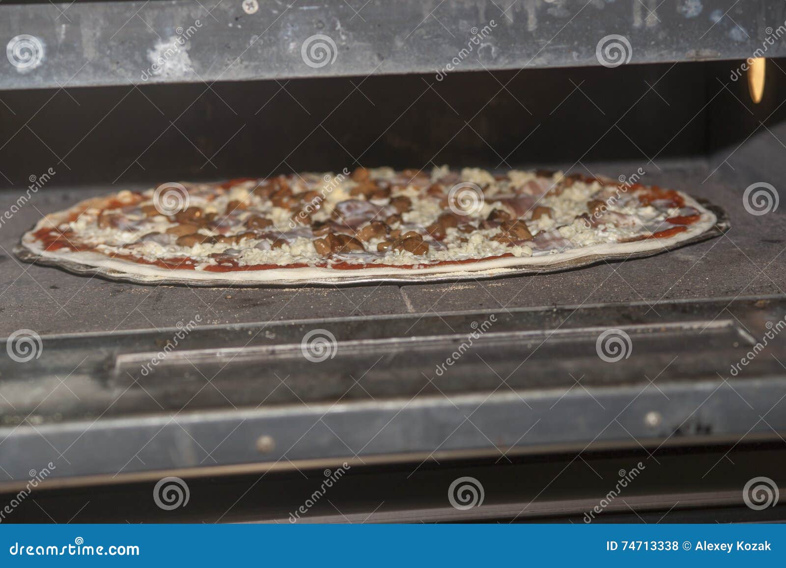 Pizza baking in the oven stock photo. Image of cheese 74713338
