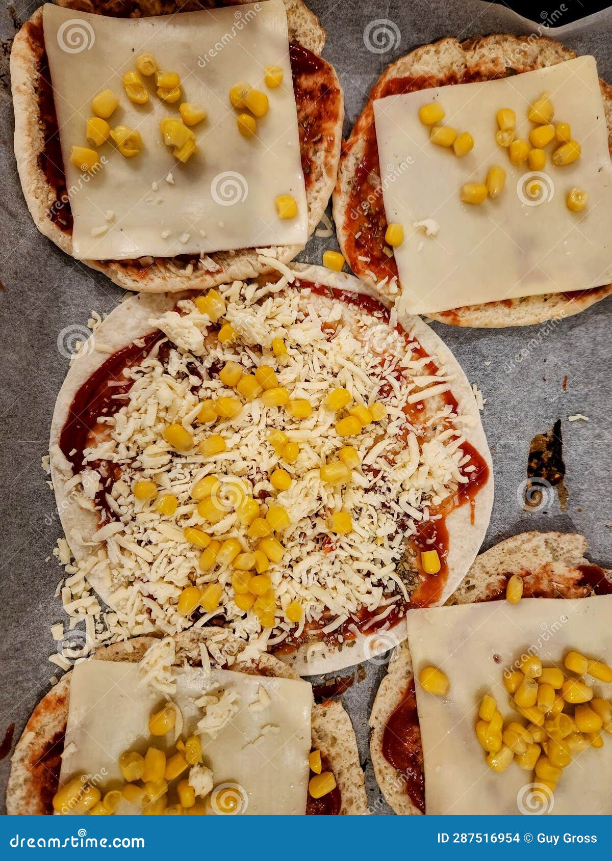 Pizza with Corn and Cheese on a Baking Sheet. Toned. Stock Photo