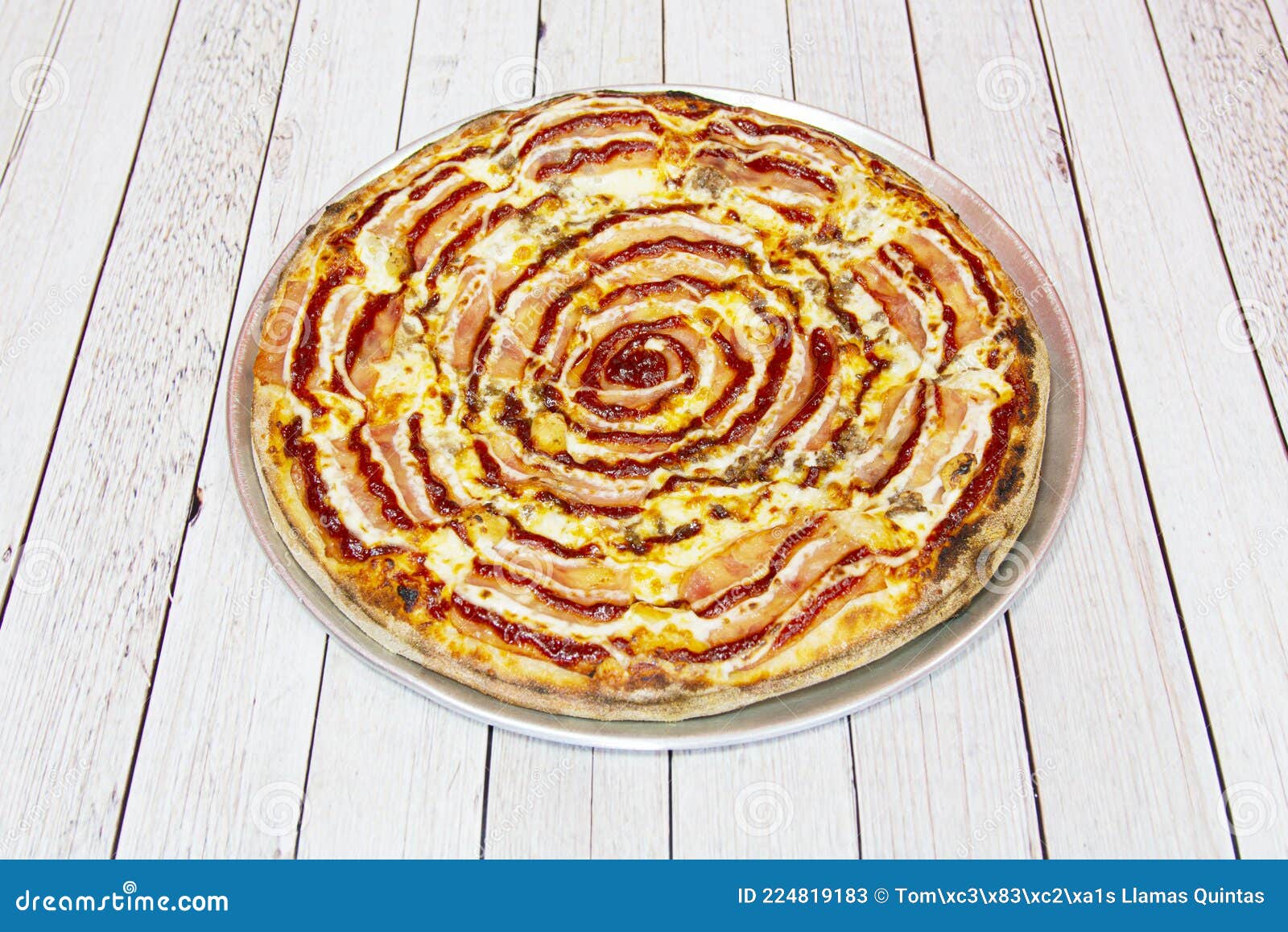 family barbecue pizza with lots of bacon and melted cheese, sauce and minced meat