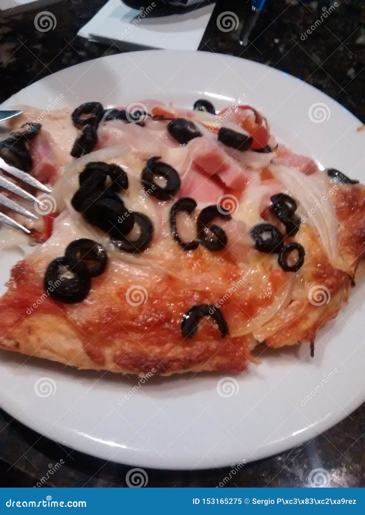 pizza racion in white dish ready to eat. with ham cheese cebolla and napoli sauce