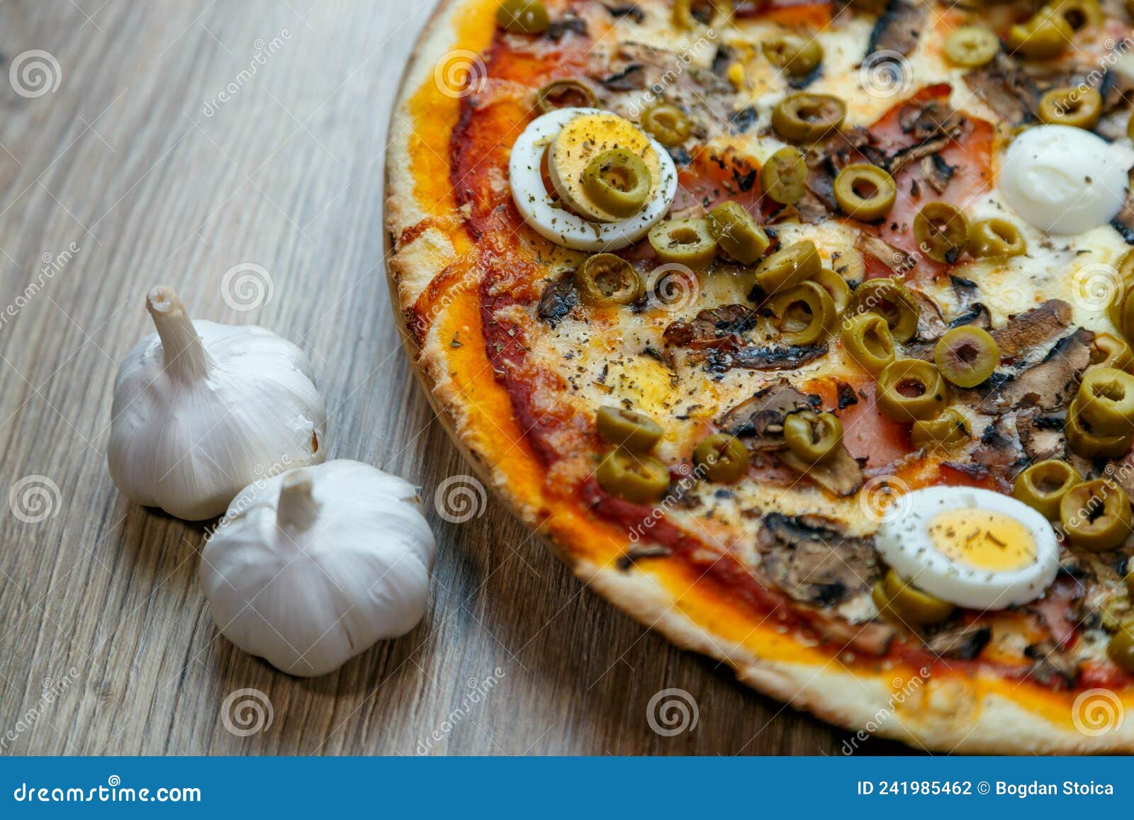 pizza with red sauce, mozarella, ham, mushroom, boiled egg, green olives detail
