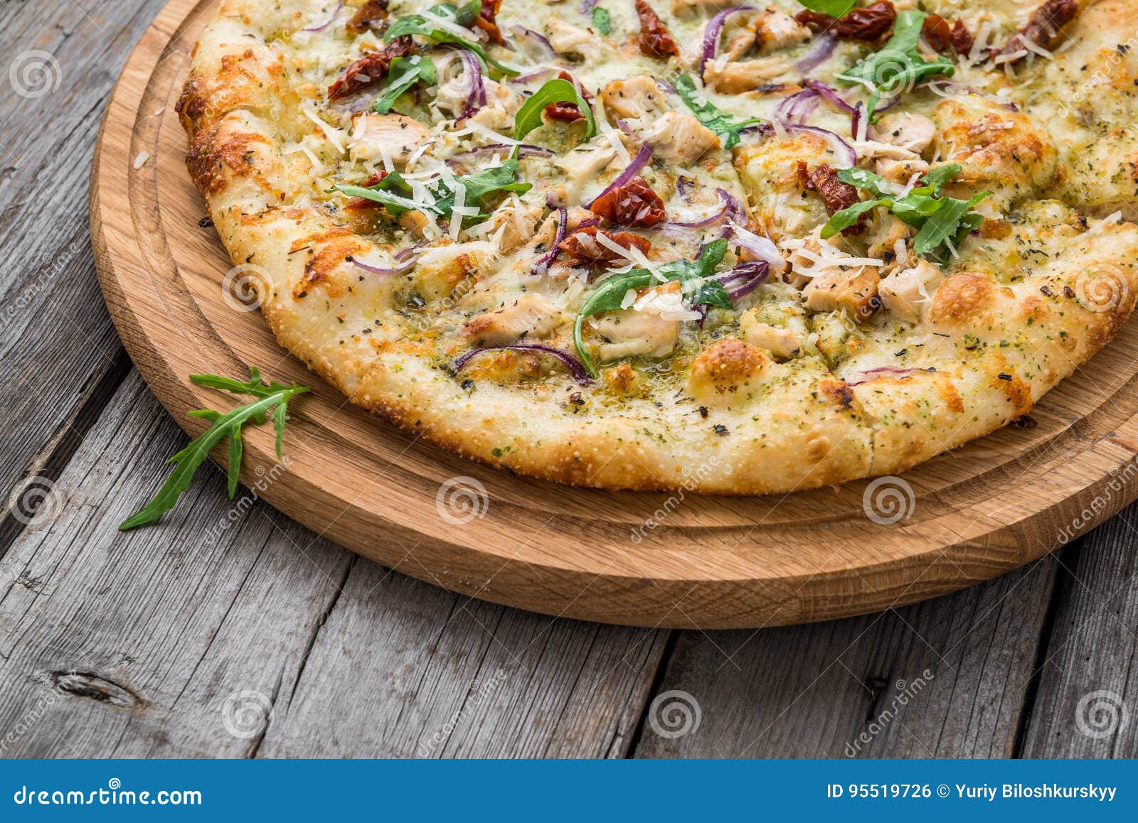Pizza with Sundried Tomatoes, Prosciutto, Arugula and Parmesan Cheese