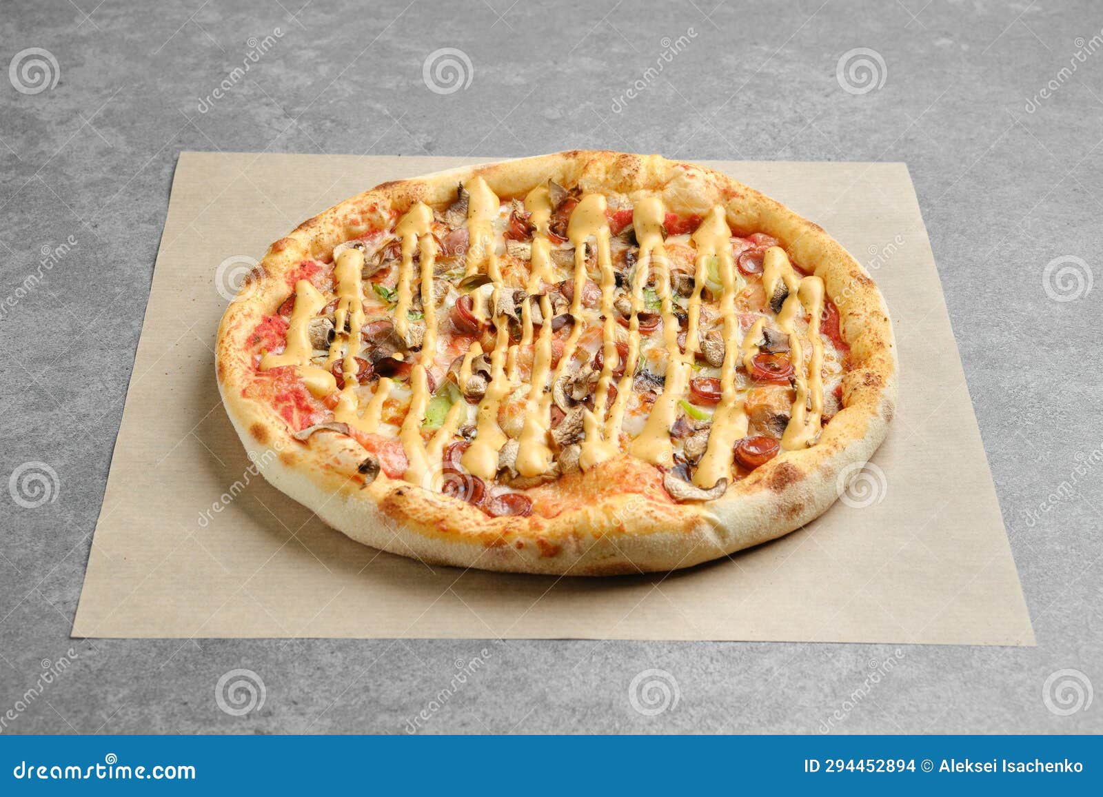 Pizza with Thin Sausage and Champignon on Parchment Paper Stock Photo
