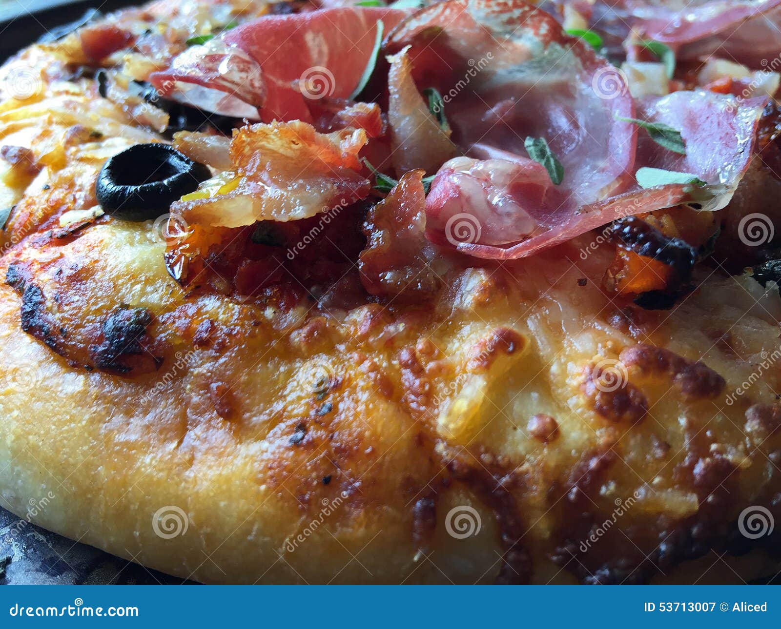 Pizza Topped with Bacon, Olives and Prosciutto Stock Image Image of