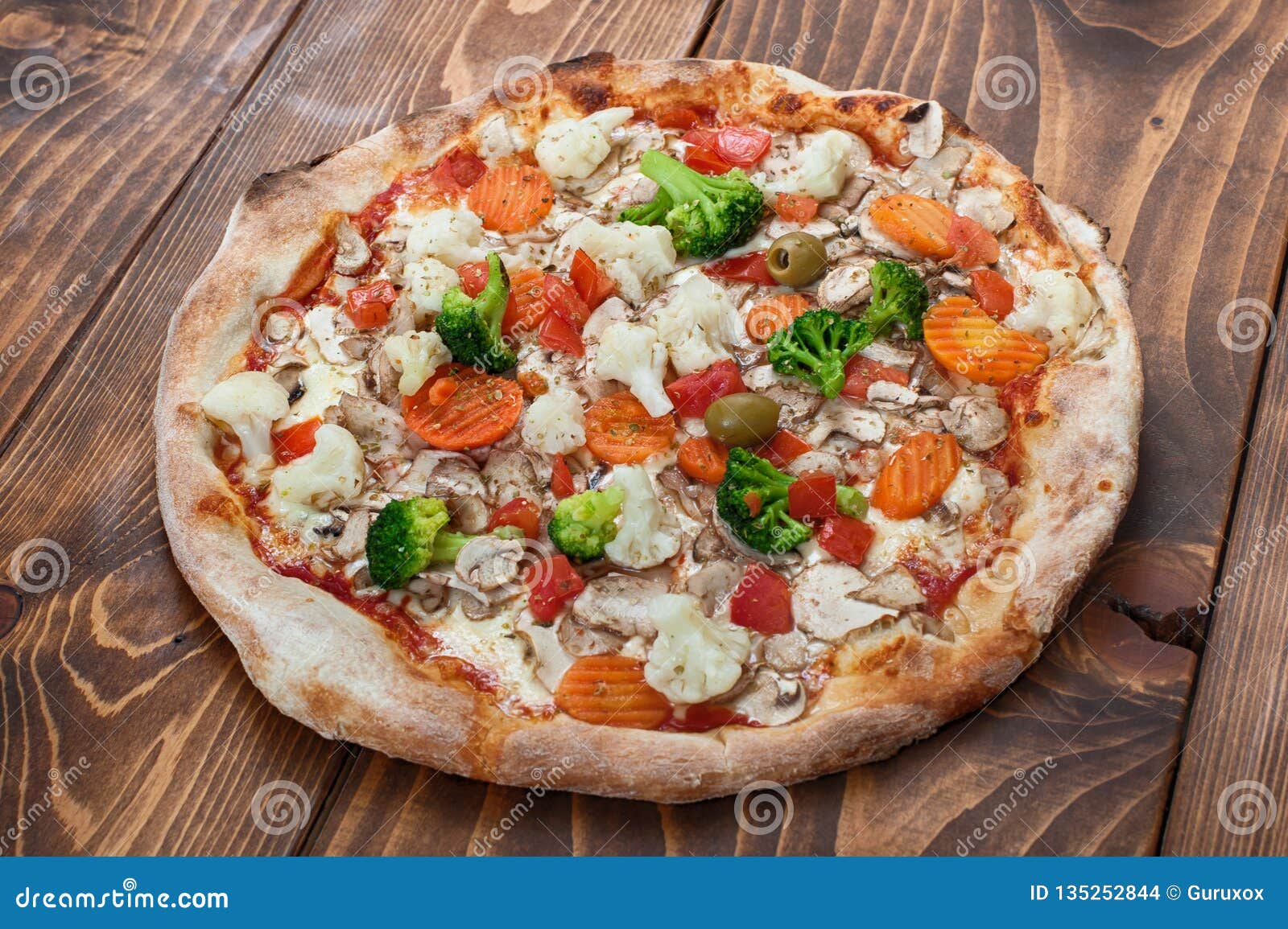 pizza vegetariana on wooden background, side view