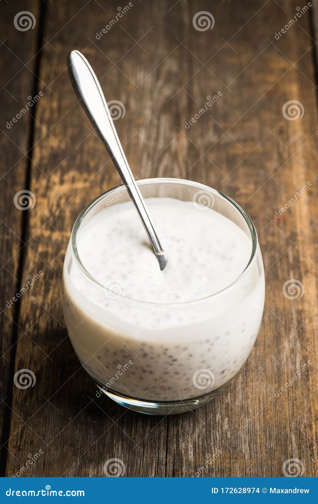 Plain Yogurt with Chia Seeds in Glass on the Rustic Wooden Background