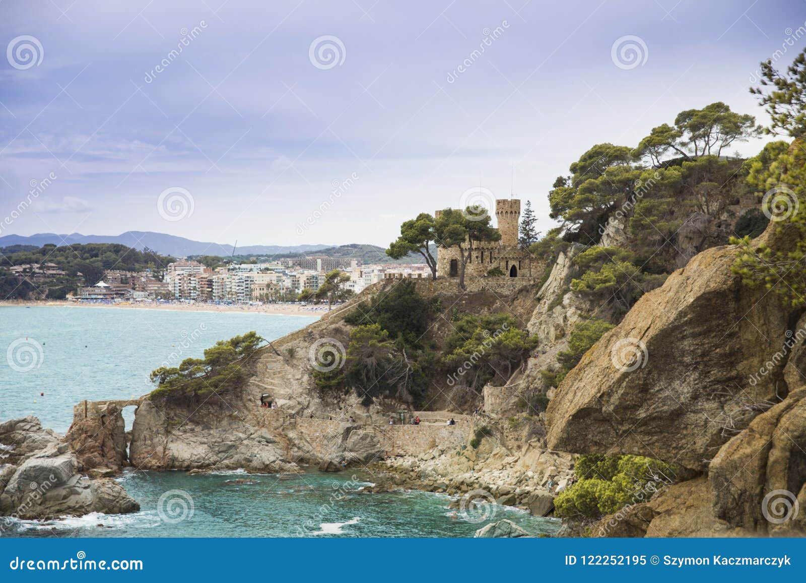 plajan on the costa brava and city beach in lloret de mar, spain. sand and sea waves.