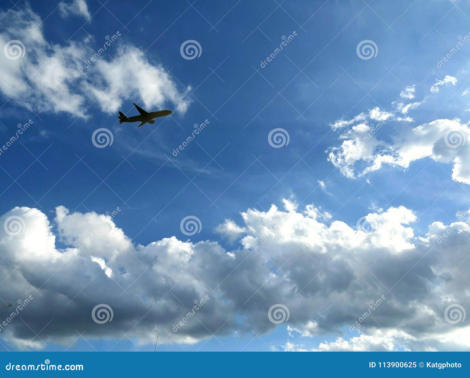Plane Flying through the Clouds in the Blue Sky Stock Image Image of