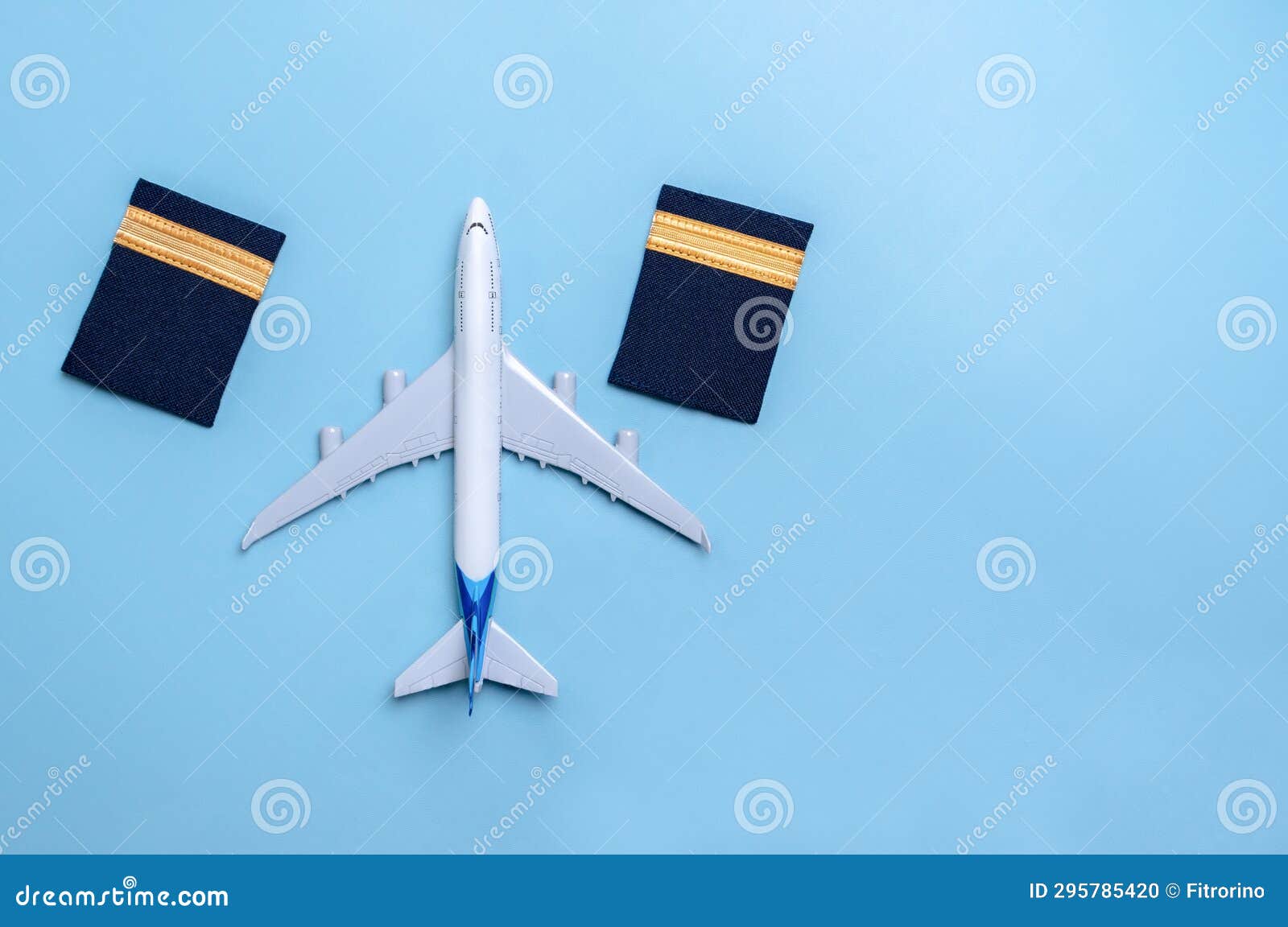 A Plane Model and Pilot Rank As First Officer Isolated on Blue Background Stock Photo Image of