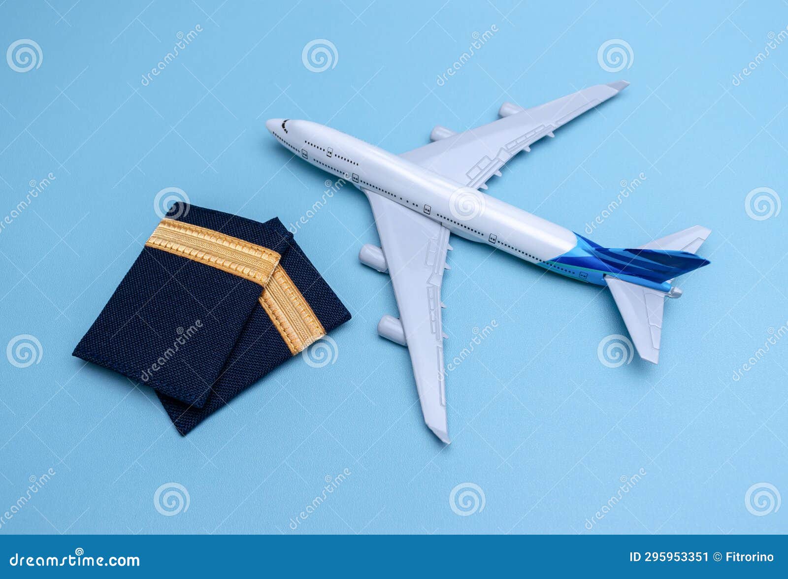 A Plane Model and Pilot Rank As First Officer Isolated on Blue Background Stock Image Image of