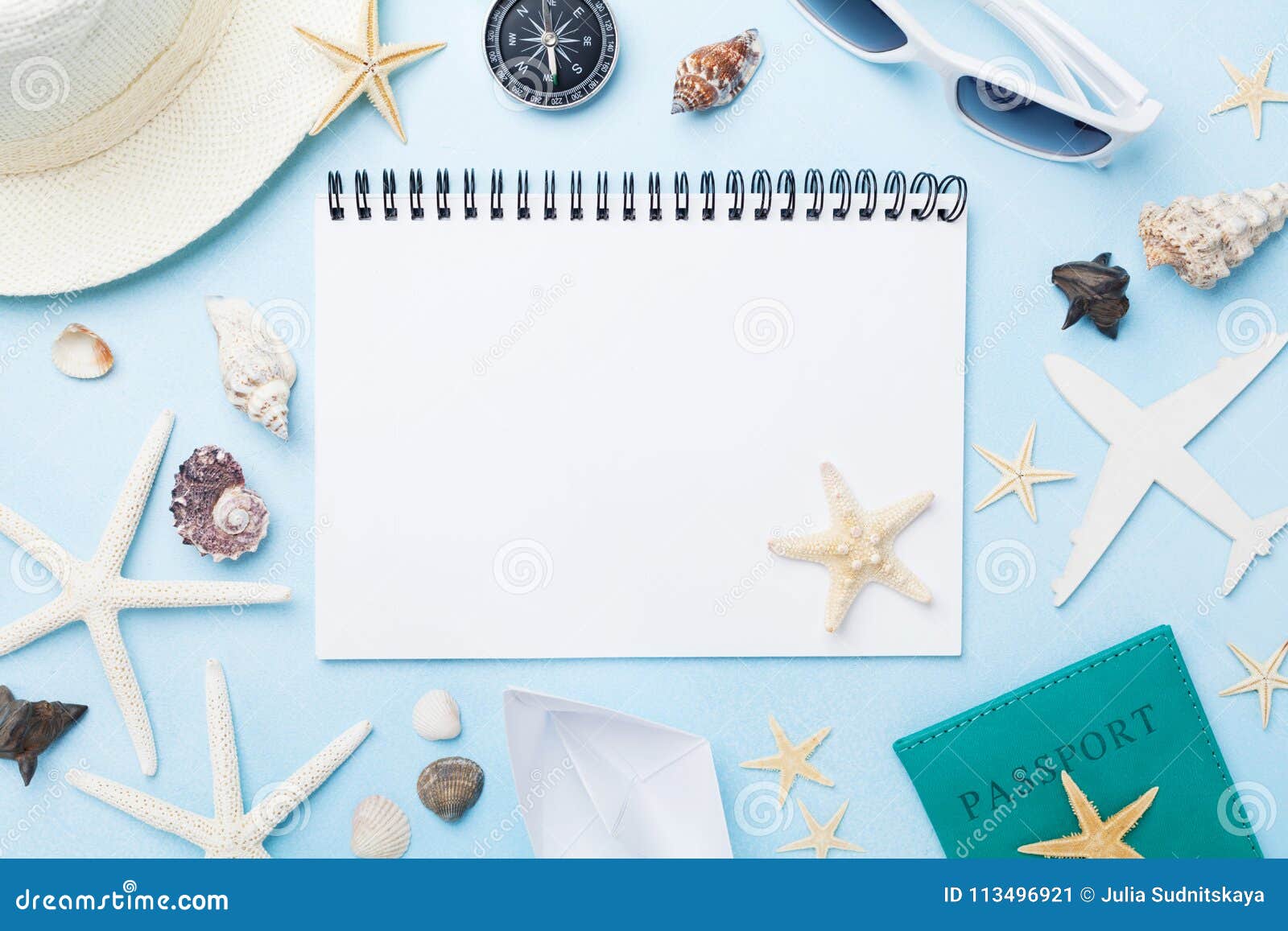 planning summer holidays, tourism and vacation background. travelers notebook with accessories on blue desk top view. flat lay.