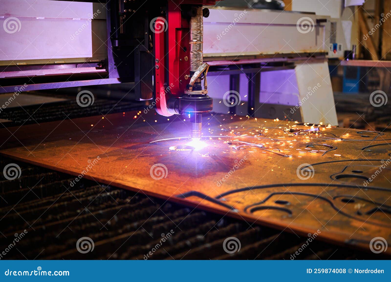Plasma Cutting of Metal Plate with Flying Sparks in Workshop Stock