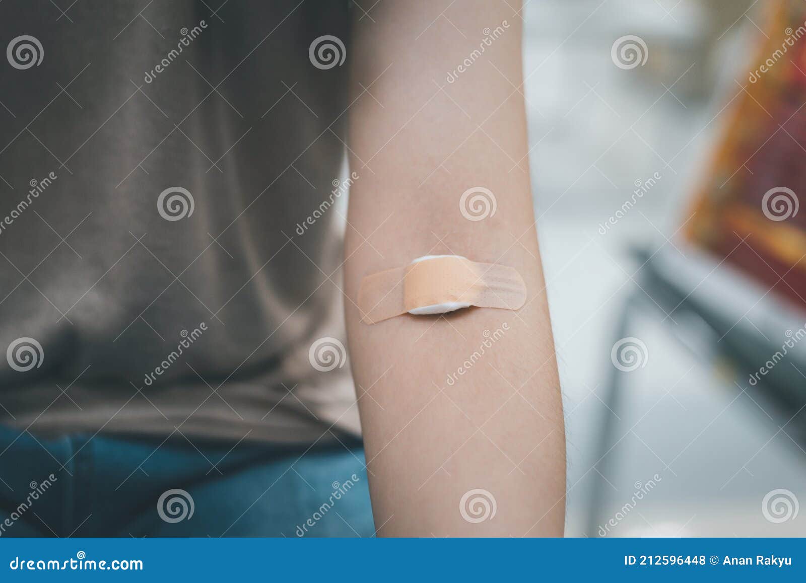 Plaster and Cotton on Woman Arm after Blood Testing or Blood Donation