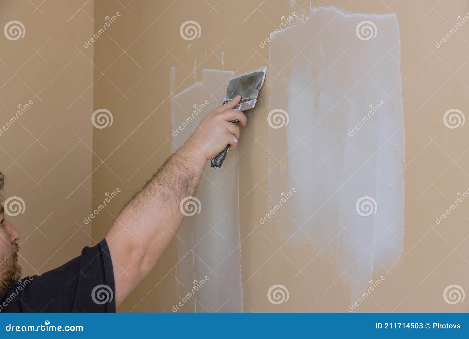 Plasterer Plastering Wall of Drywall at a Construction Damaged Wall