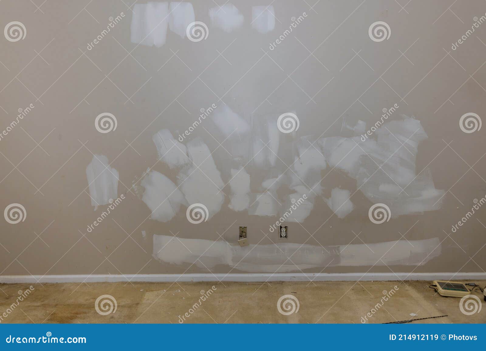 Plasterer Plastering Wall of Drywall at a Construction Damaged Wall