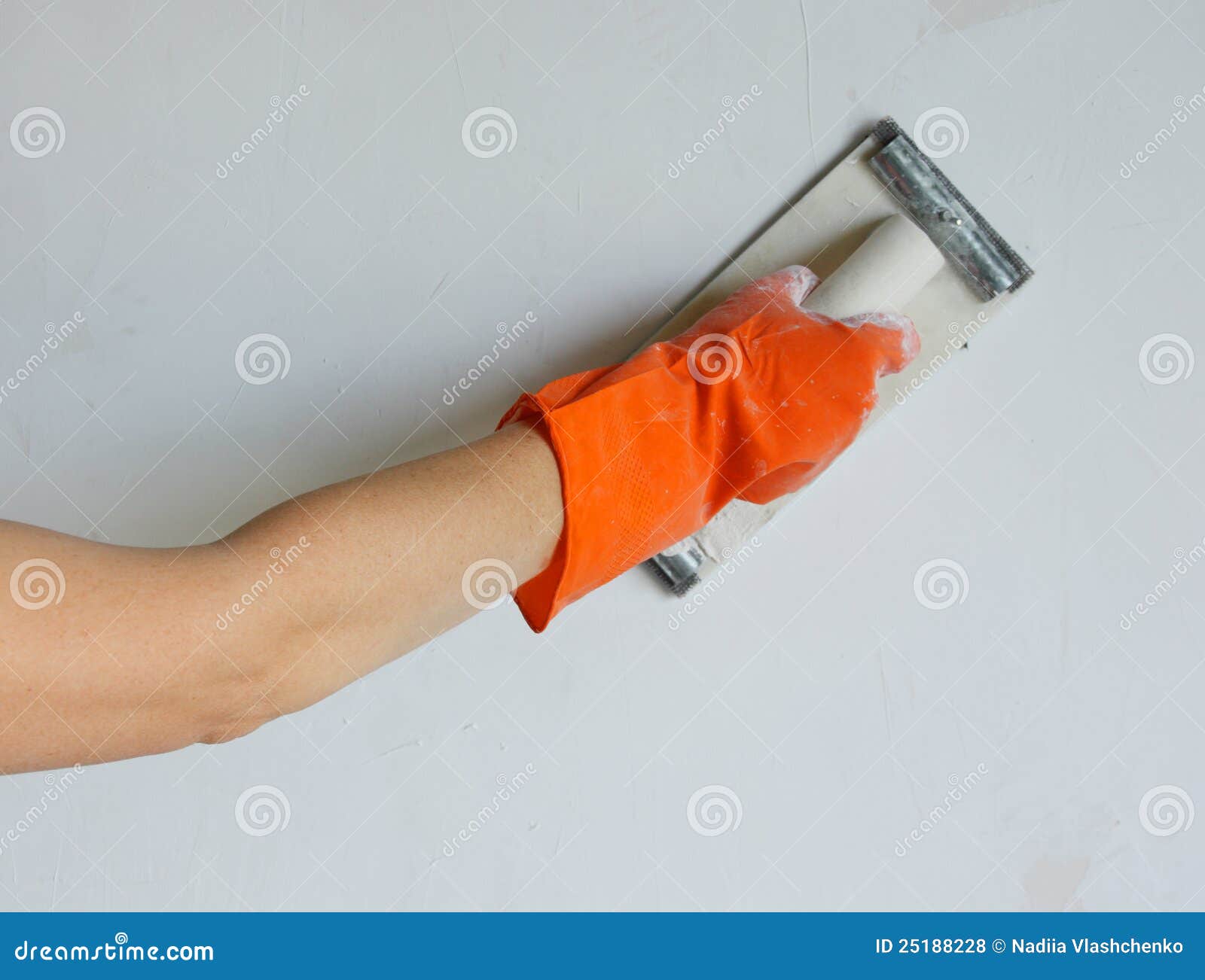 plasterer smoothing out wall with trowel