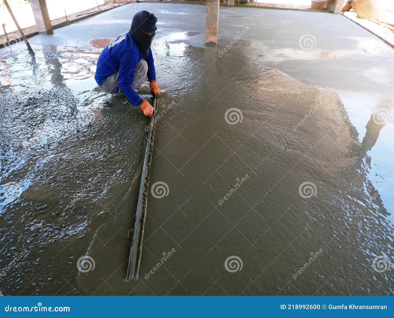 Plasterers are Using Equipment To Smooth the Plaster Stock Photo