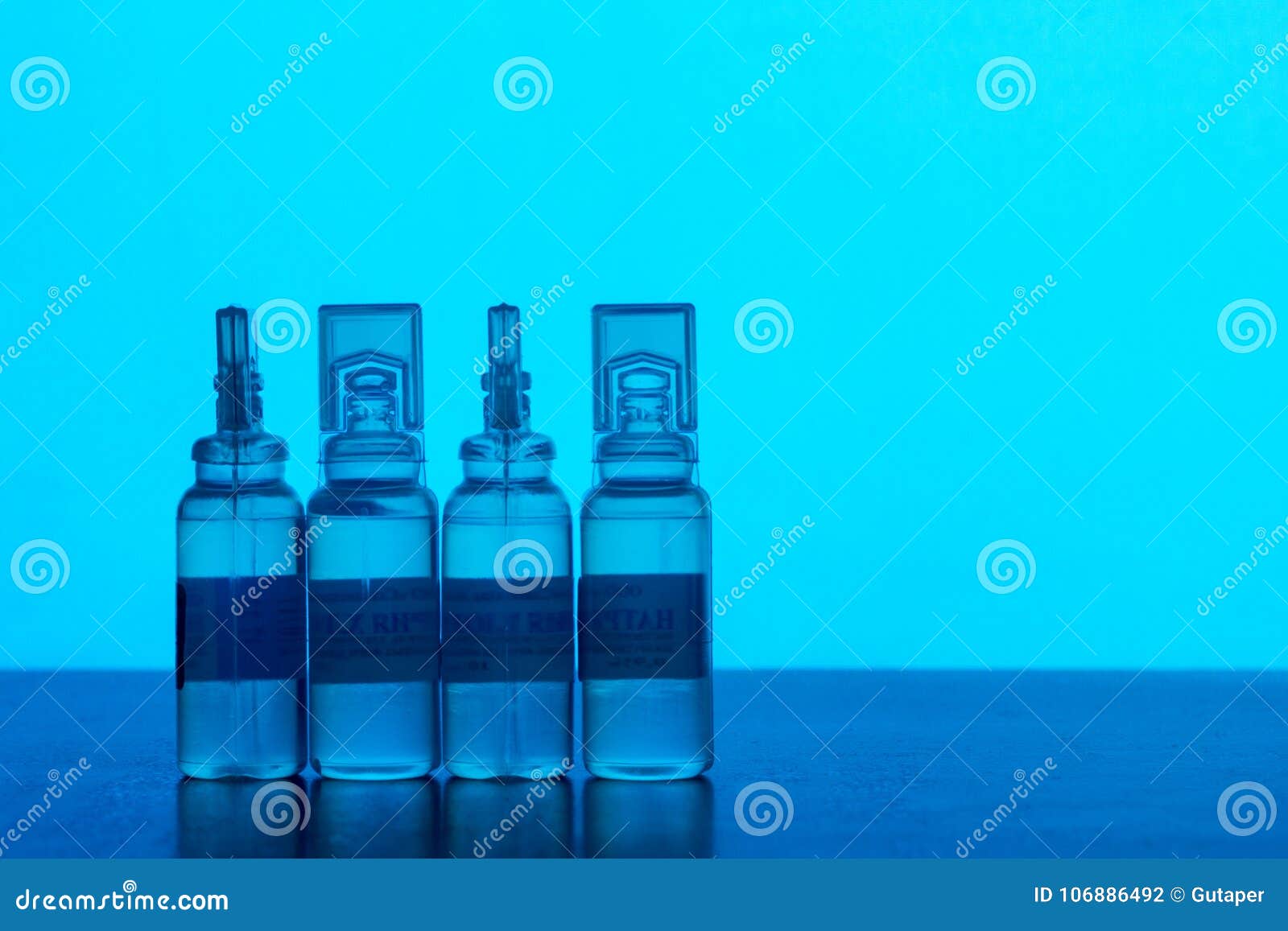 Plastic Ampoules with Solution for Injections on the Blue Background