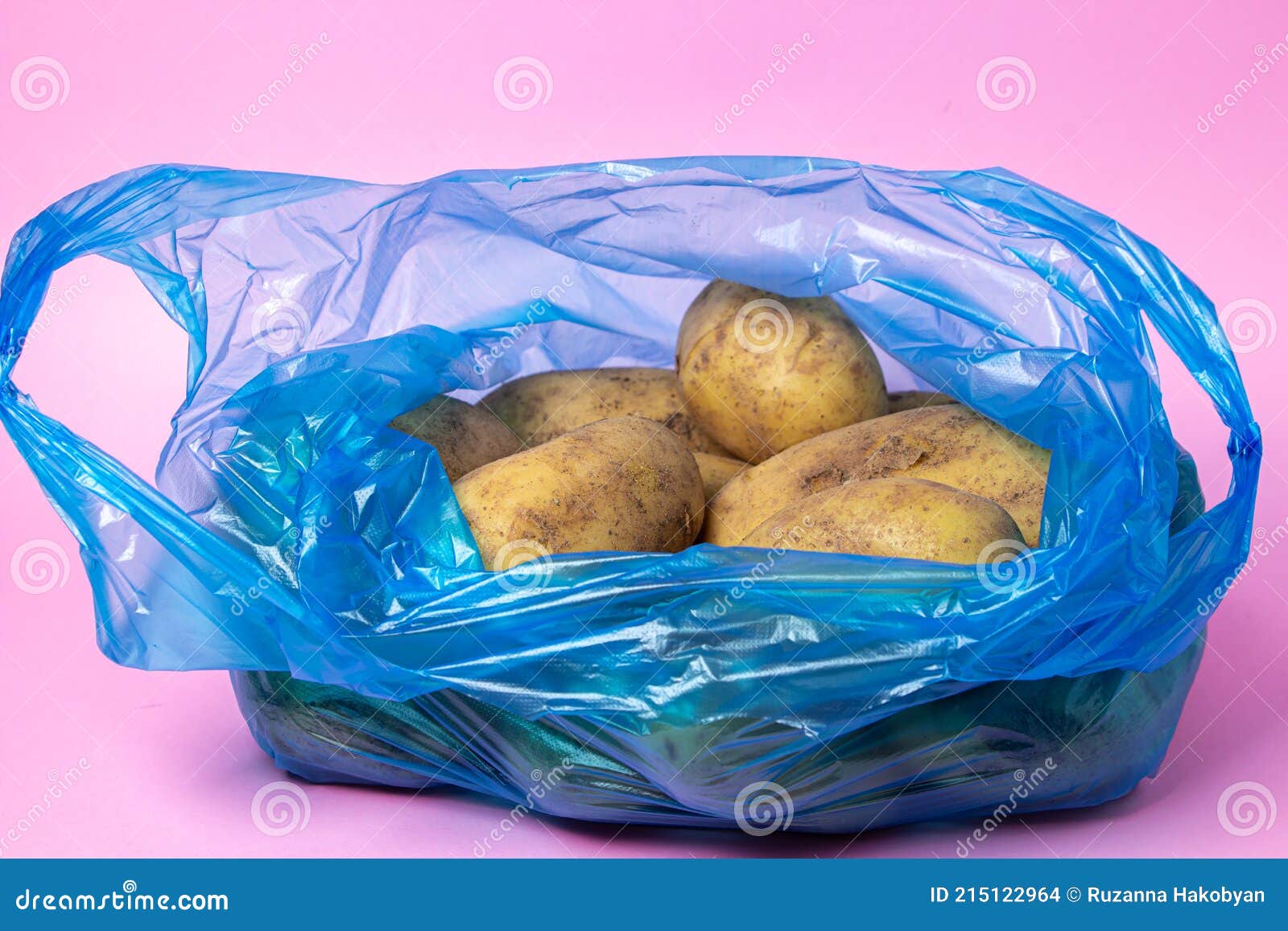 Plastic Bag with Potatoes on a Pink Background. Stock Photo Image of
