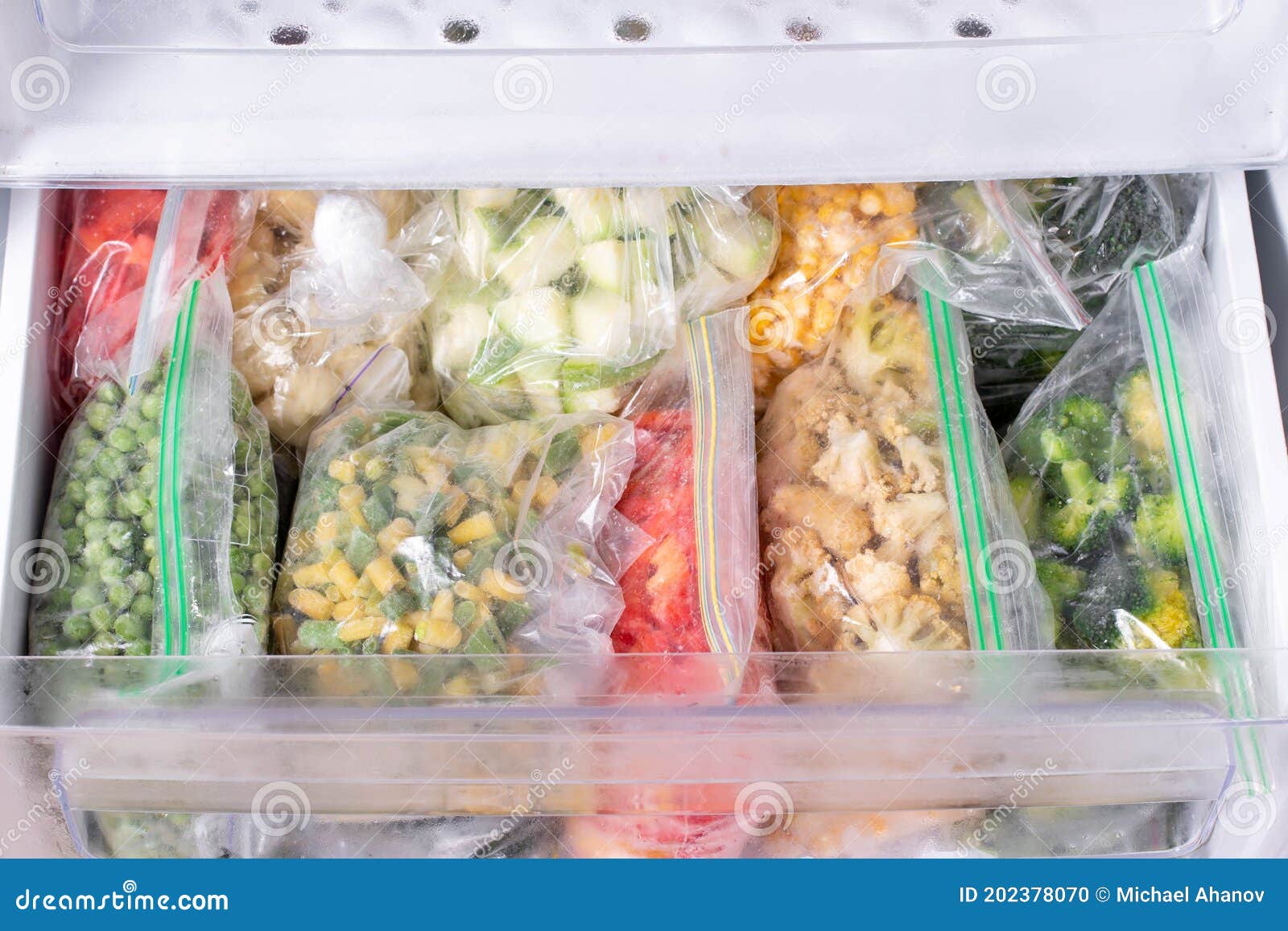 Plastic Bags with Deep Frozen Vegetables in Refrigerator Stock Photo