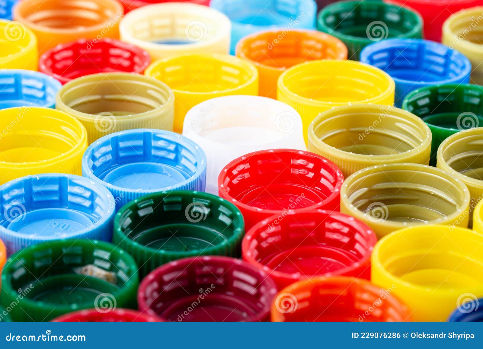 Plastic Bottle Caps Background. Cap Material is Recyclable Stock Photo