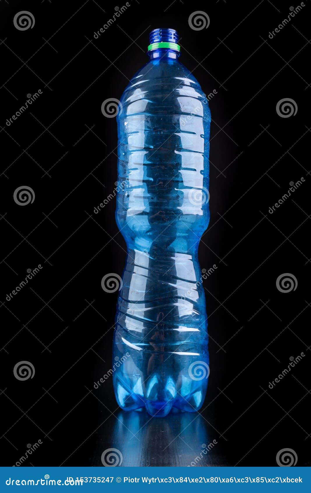Plastic Bottle on a Dark Table. Plastic Container for Drinking Water