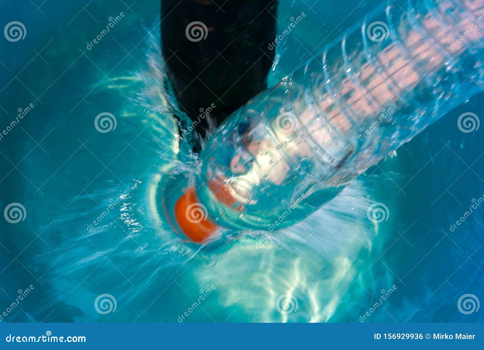 Plastic Bottle Falling into the Water Making Splashes and Spraying