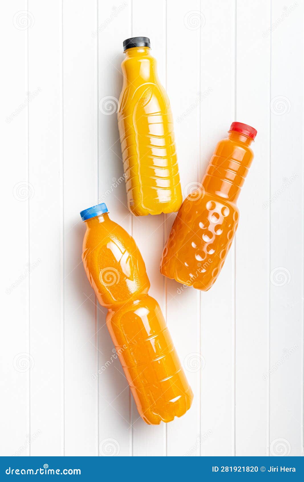 A Plastic Bottle of Fruit Juice. Orange Juice on White Table Stock