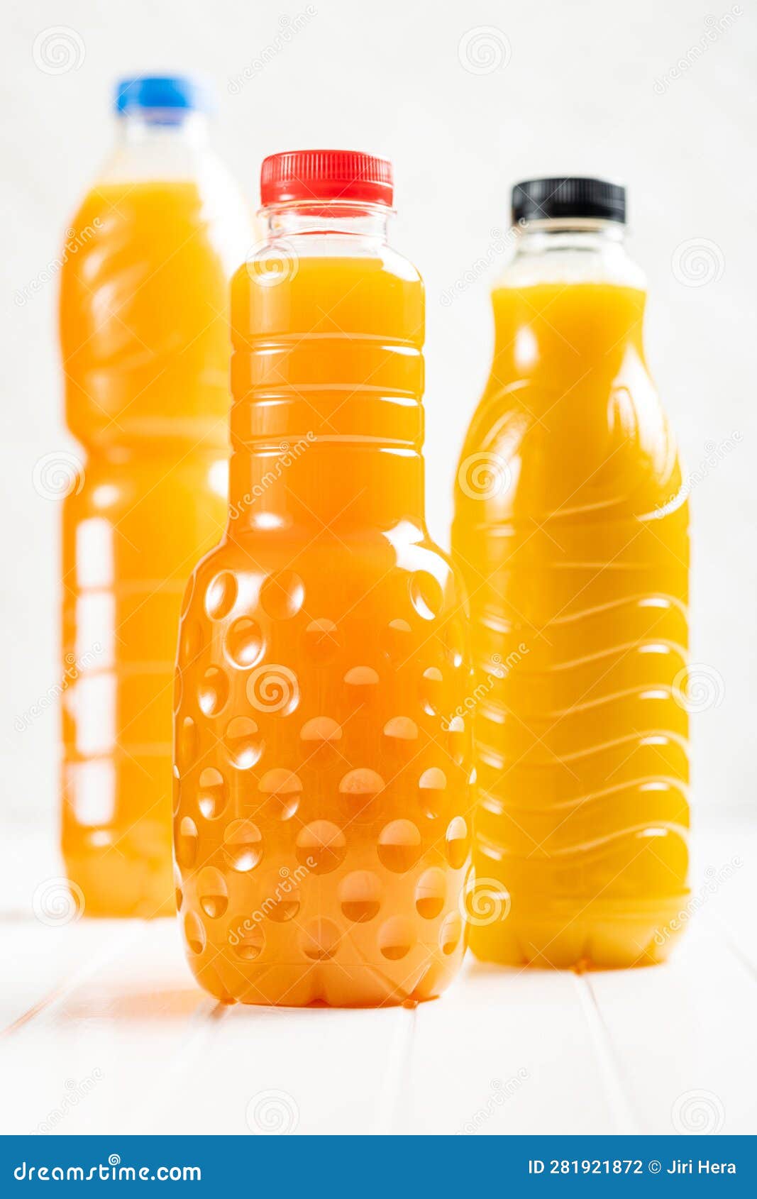 A Plastic Bottle of Fruit Juice. Orange Juice on White Table Stock
