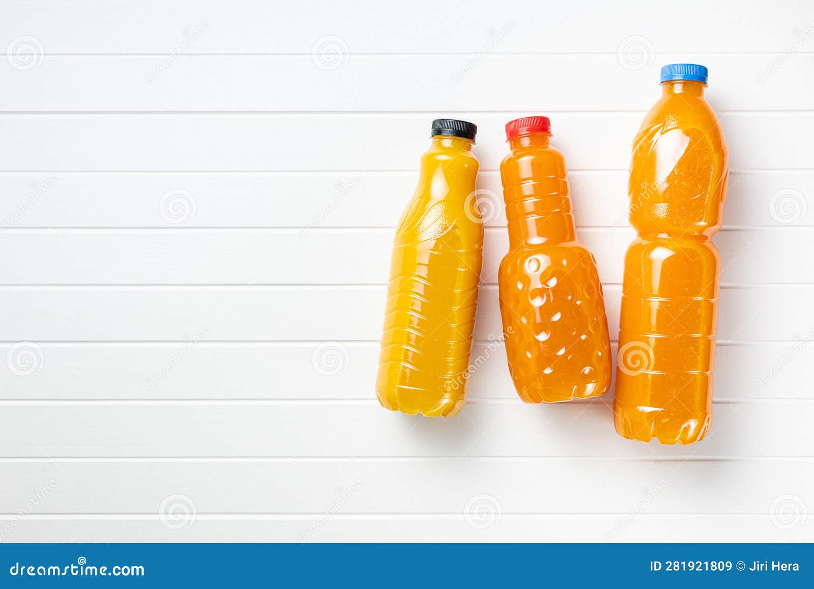 A Plastic Bottle of Fruit Juice. Orange Juice on White Table. Top View