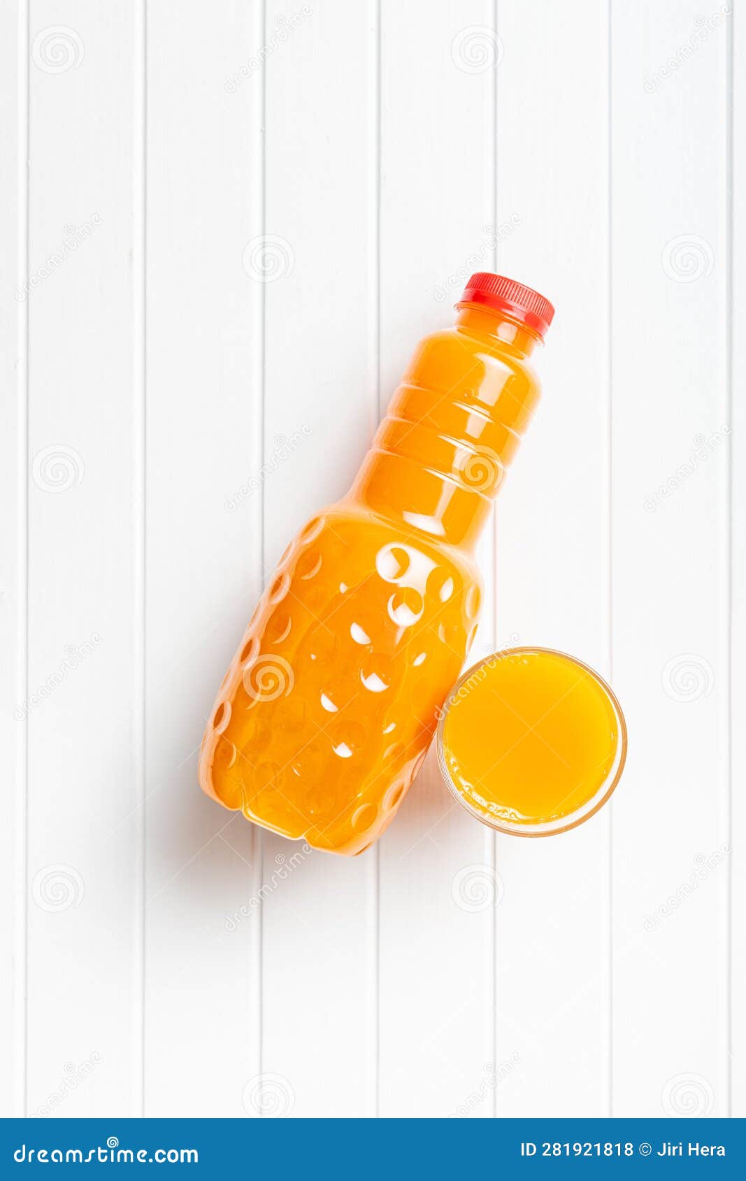 A Plastic Bottle of Fruit Juice. Orange Juice on White Table. Top View