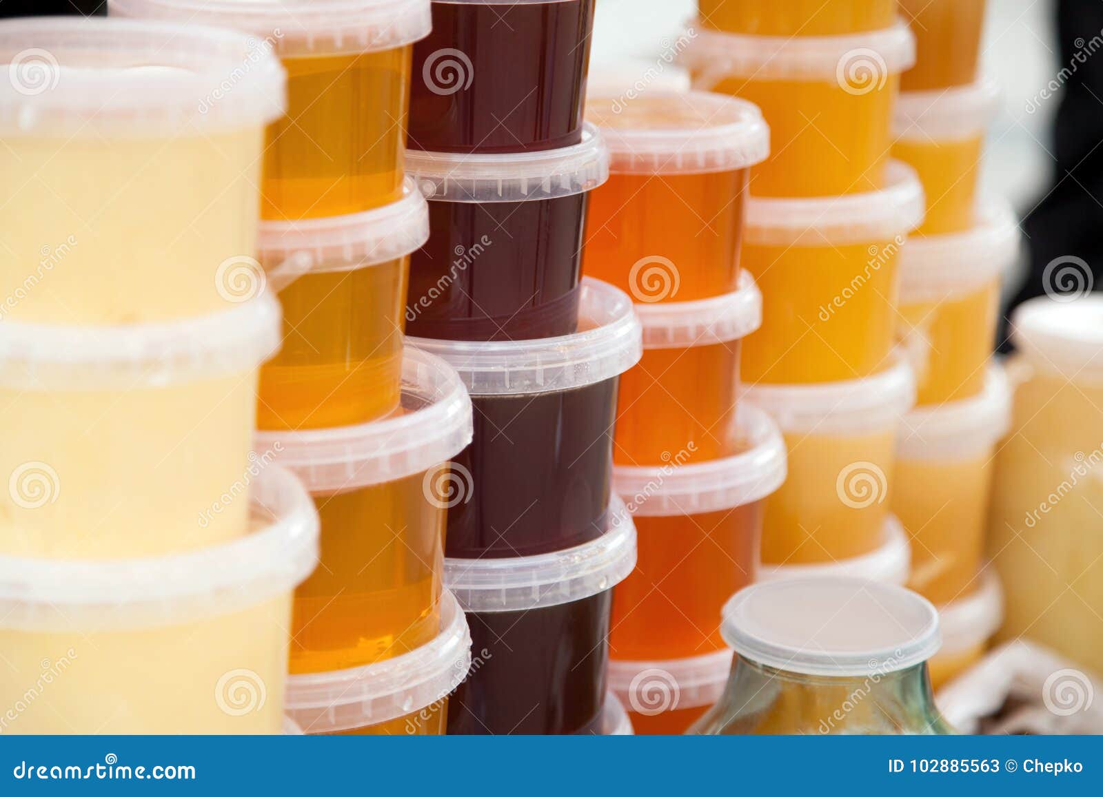 Plastic bucket with honey stock image. Image of market 102885563